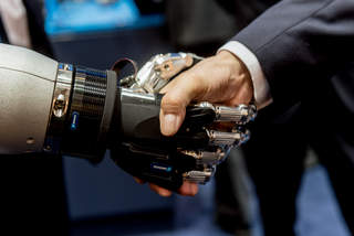 roboter and human shake hands