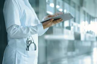 doctor with tablet in hand